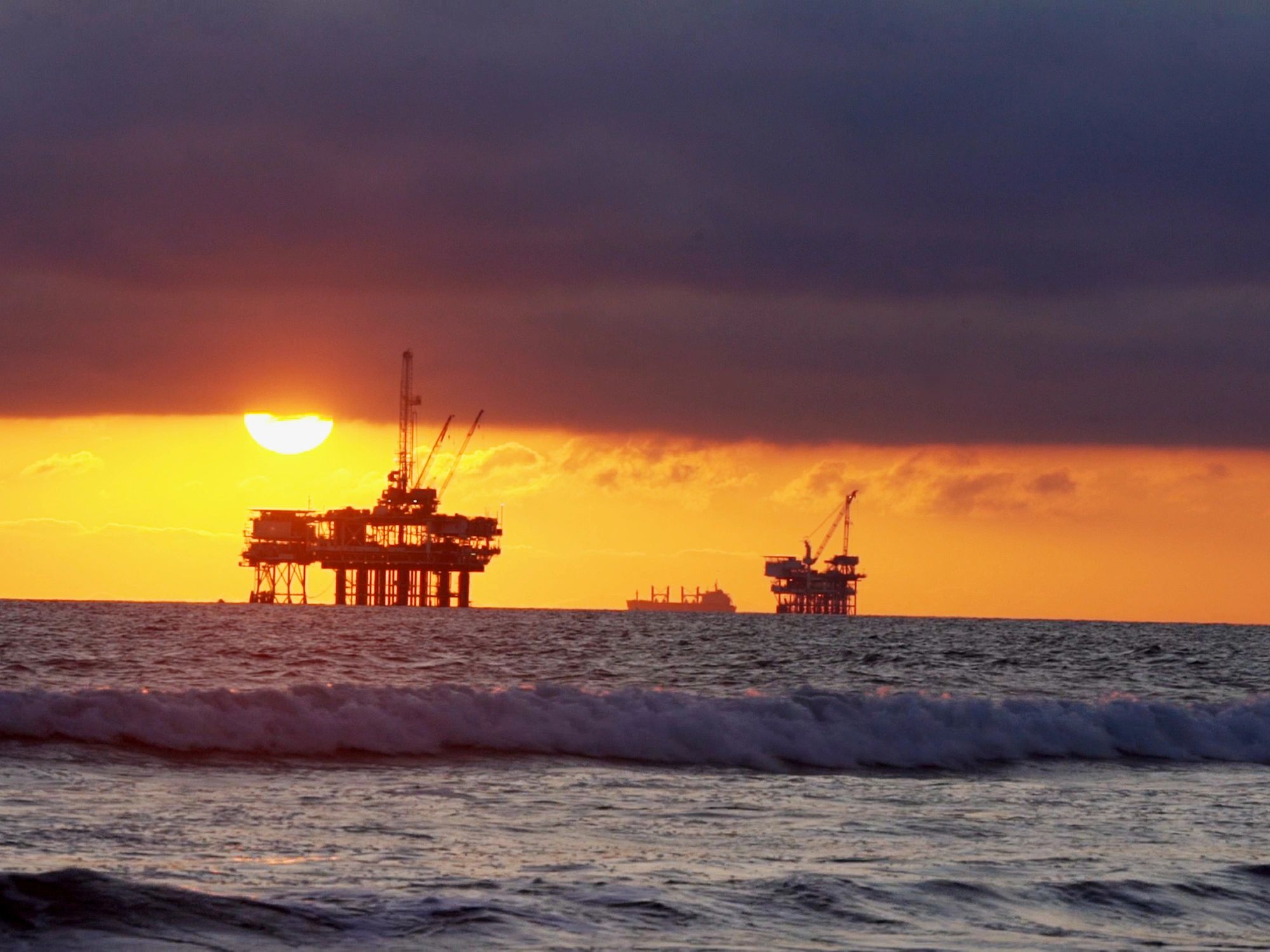 Offshore oil platforms at sunset