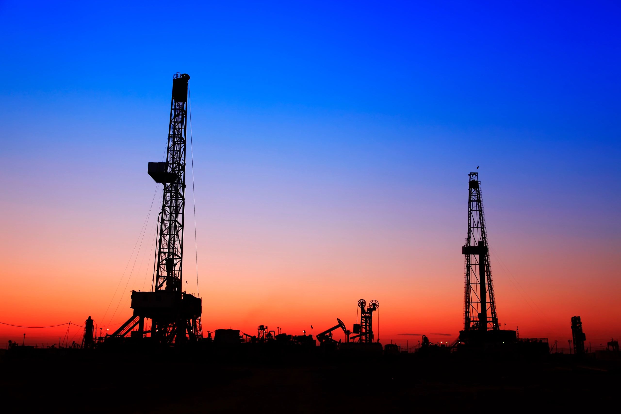 Offshore oil platforms at ocean sunset